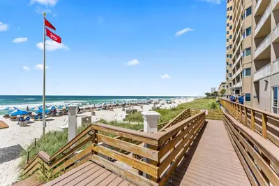 a boardwalk leading to the beach at a resort at Ocean Front Condo 29th Floor - Must be 25 to Book in Panama City Beach