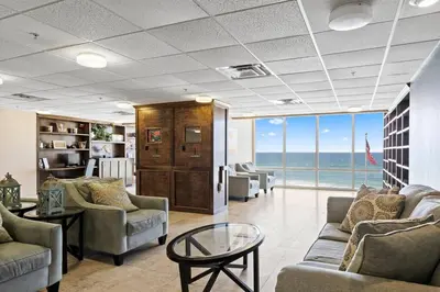 a living room with couches and a view of the ocean at Ocean Front Condo 29th Floor - Must be 25 to Book in Panama City Beach