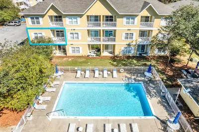 an overhead view of a swimming pool in front of a building at Coastside 2 BR with 2BA Sleeps 6 Bikes and Pool View in Santa Rosa Beach