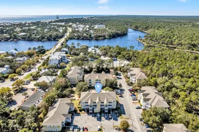 an aerial view of a resort with a river and buildings at Coastside 2 BR with 2BA Sleeps 6 Bikes and Pool View in Santa Rosa Beach