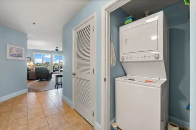a laundry room with a washer and dryer at Laketown Wharf #320 by Nautical Properties in Panama City Beach