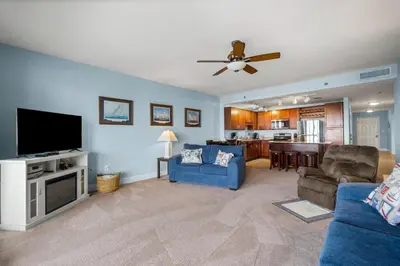 a living room with a flat screen tv and a couch at Laketown Wharf #320 by Nautical Properties in Panama City Beach