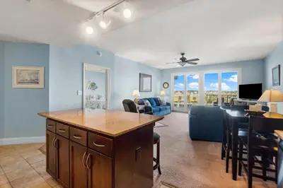 a living room with a kitchen and a dining room at Laketown Wharf #320 by Nautical Properties in Panama City Beach