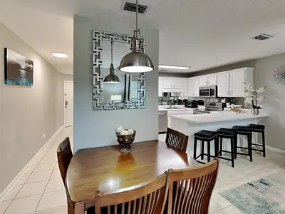 a kitchen and dining room with a table and chairs at Horizon South 60-203 in Panama City Beach
