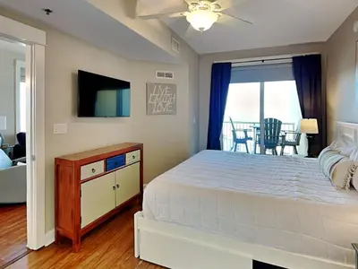 a bedroom with a large bed and a television at Grand Panama Beach Resort - The Grand II #1108 in Panama City Beach