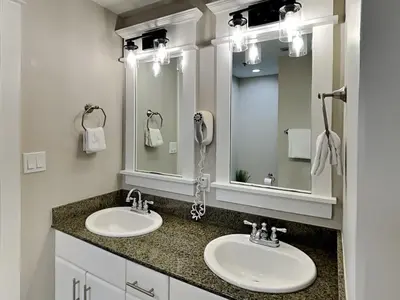 a bathroom with two sinks and a large mirror at Grand Panama Beach Resort - The Grand II #1108 in Panama City Beach