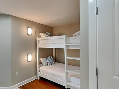 a bunk room with white bunk beds in it at Grand Panama Beach Resort - The Grand II #1108 in Panama City Beach