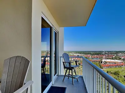 a balcony with two chairs and a view at Grand Panama Beach Resort - The Grand II #1108 in Panama City Beach