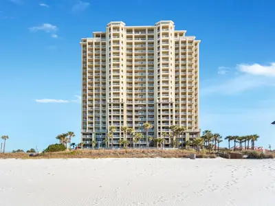 a tall building on the beach next to the ocean at Grand Panama Beach Resort - The Grand II #1108 in Panama City Beach