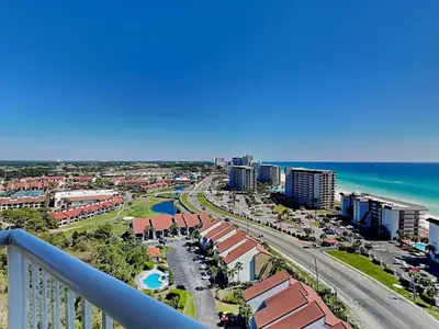 a view of the beach from the balcony of a resort at Grand Panama Beach Resort - The Grand II #1108 in Panama City Beach