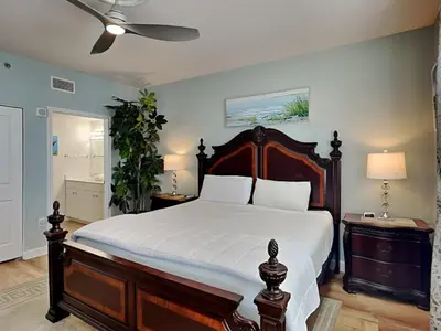 a bedroom with a large bed and a ceiling fan at Shores of Panama #1129 in Panama City Beach