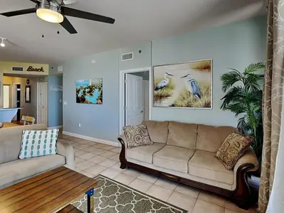 a living room with a couch and a table at Shores of Panama #1129 in Panama City Beach