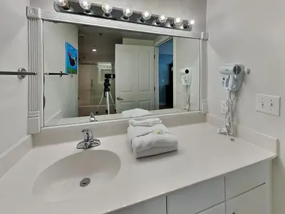 a bathroom with a sink and a large mirror at Shores of Panama #1129 in Panama City Beach