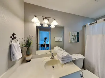 a bathroom with a sink and a mirror at Tidewater Beach Resort #1501 in Panama City Beach