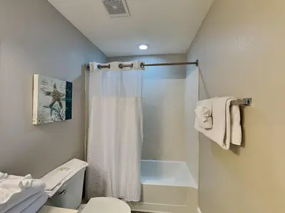 a bathroom with a shower curtain and a toilet at Tidewater Beach Resort #1501 in Panama City Beach