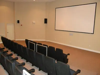 a lecture room with chairs and a white screen at Tidewater Beach Resort #1501 in Panama City Beach