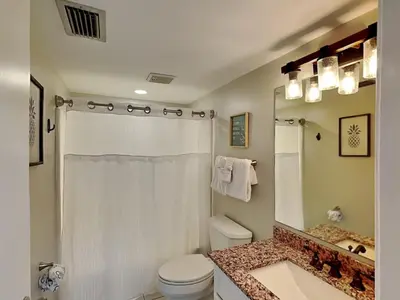 a bathroom with a toilet and a shower and a sink at Edgewater Villa #121 in Panama City Beach