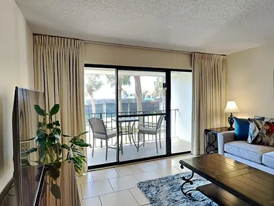 a living room with a couch and a table at Edgewater Villa #2607 in Panama City Beach