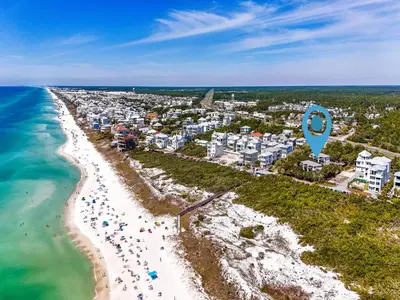 an aerial view of a beach with a blue marker at Inlet Dunes #102 in Inlet Beach