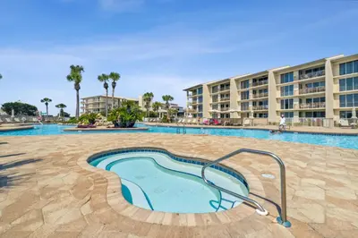 a swimming pool at a resort with a building at HP 325 Sandy Bottoms by 30A Escapes in Rosemary Beach