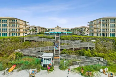 a resort with a staircase on the beach with buildings at HP 325 Sandy Bottoms by 30A Escapes in Rosemary Beach