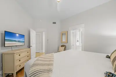 a bedroom with a bed and a television on a dresser at The Legacy Unit 203 in Seagrove Beach