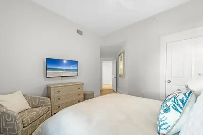 a bedroom with a bed and a couch and a tv at The Legacy Unit 203 in Seagrove Beach