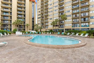 a swimming pool in front of some apartment buildings at Summerhouse Beach Resort by Panhandle Getaways in Panama City Beach