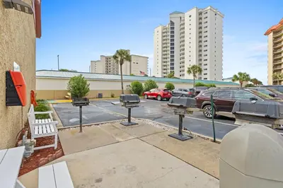 a parking lot with cars parked in a parking lot at Summerhouse Beach Resort by Panhandle Getaways in Panama City Beach