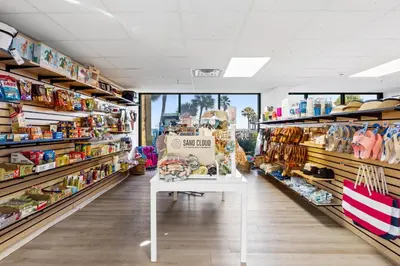 a store aisle with a white table in a store at Summerhouse Beach Resort by Panhandle Getaways in Panama City Beach