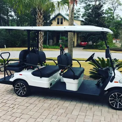 a golf cart with two seats on a driveway at Free Golf Cart, 5 min to Beach, Community Pool in Inlet Beach