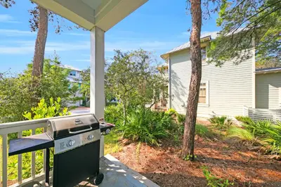 a grill on the porch of a house at Free Golf Cart, 5 min to Beach, Community Pool in Inlet Beach
