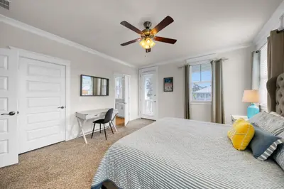 a bedroom with a bed and a ceiling fan at Free Golf Cart, 5 min to Beach, Community Pool in Inlet Beach