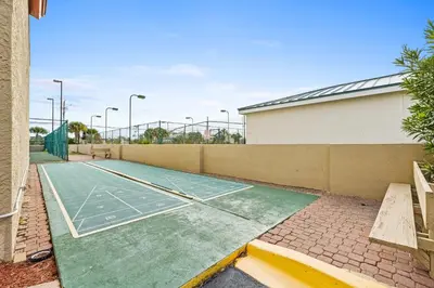 a tennis court is on a tennis court at Summerhouse Beach Resort by Panhandle Getaways in Panama City Beach
