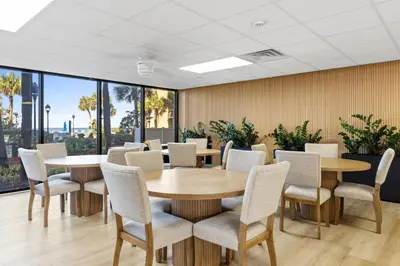 a conference room with tables and chairs and large windows at Summerhouse Beach Resort by Panhandle Getaways in Panama City Beach