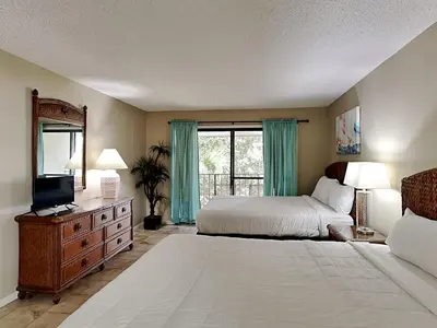 a large bedroom with a bed and a television at Edgewater Villa #1607 in Panama City Beach