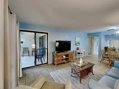 a living room with a couch and a tv at Edgewater Villa #1607 in Panama City Beach