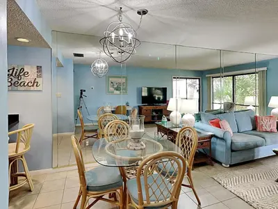 a living room with a table and a couch at Edgewater Villa #1607 in Panama City Beach