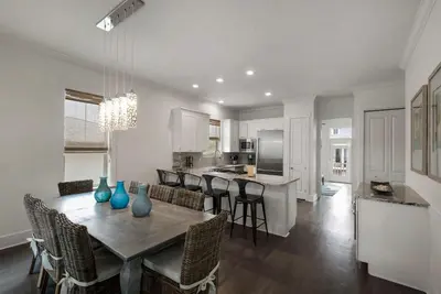 a kitchen and dining room with a table and chairs at Beach House with Heated Pool 100 Steps from Beach in Panama City Beach
