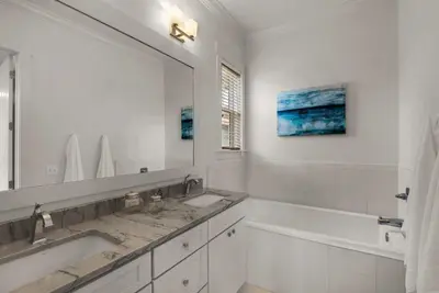 a bathroom with two sinks and a large mirror at Beach House with Heated Pool 100 Steps from Beach in Panama City Beach