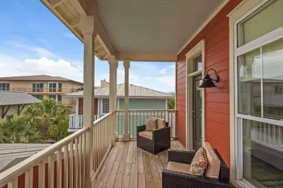 a porch of a home with a view of the ocean at Beach House with Heated Pool 100 Steps from Beach in Panama City Beach