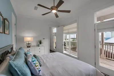 a bedroom with a bed and a ceiling fan at Beach House with Heated Pool 100 Steps from Beach in Panama City Beach