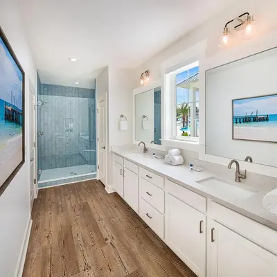a bathroom with two sinks and a shower at Margaritaville Beach Cottage Resort Panama City Beach in Panama City Beach