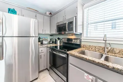 a kitchen with a refrigerator and a sink at Beachside Villas 814 in Santa Rosa Beach