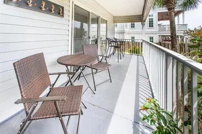 a row of chairs and tables on a porch at Beachside Villas 814 in Santa Rosa Beach
