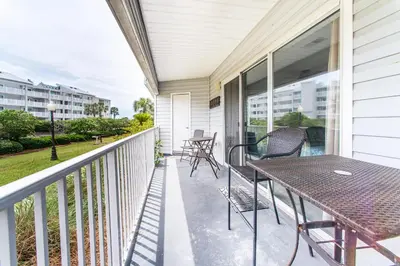a patio with a table and chairs on a balcony at Beachside Villas 814 in Santa Rosa Beach
