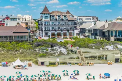 a group of people on a beach in front of buildings at Beachside Villas 814 in Santa Rosa Beach