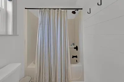 a bathroom with a shower curtain and a tub at Beachside Villas 1123- A Sandy Carol in Santa Rosa Beach