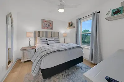 a bedroom with a bed and a window at Beachside Villas 1123- A Sandy Carol in Santa Rosa Beach