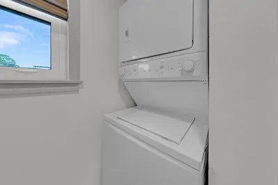 a washer and dryer in a kitchen with a window at Beachside Villas 1123- A Sandy Carol in Santa Rosa Beach